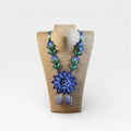 Collares Huichol de chaquira, flor principal azul intenso y hojas verdes.