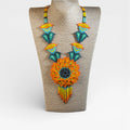 Collares: Girasol Huichol de chaquira naranja, amarillo y azul turquesa.