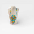 Collares: Collar Huichol de chaquira Turquesa, Naranja y Amarillo, patrón geométrico y flecos.