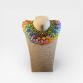 Collares: Chaquira Huichol con flores multicolor, patrón geométrico negro y amarillo.